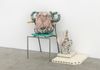 Carl Mannov. Pots, 2016. Glazed stoneware, egg tempera, concrete, foam cushion, oven plates, book and chair. 84 x 100 x 50 cm 
