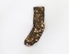 Lina Viste Grønli. Pentimento Sock (Black), 2016. Sock, US pennies, silicone. 1 x 10 x 39 cm